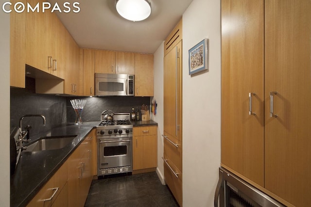 kitchen with decorative backsplash, sink, and appliances with stainless steel finishes