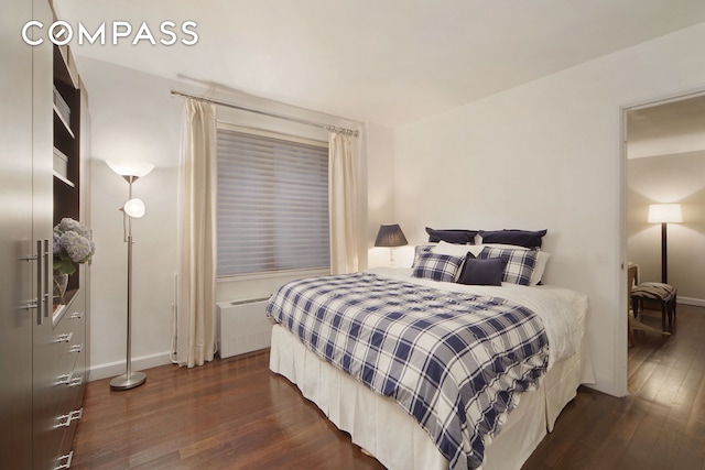 bedroom with baseboards and dark wood finished floors