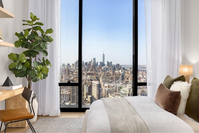 bedroom with a skyline view and a wall of windows