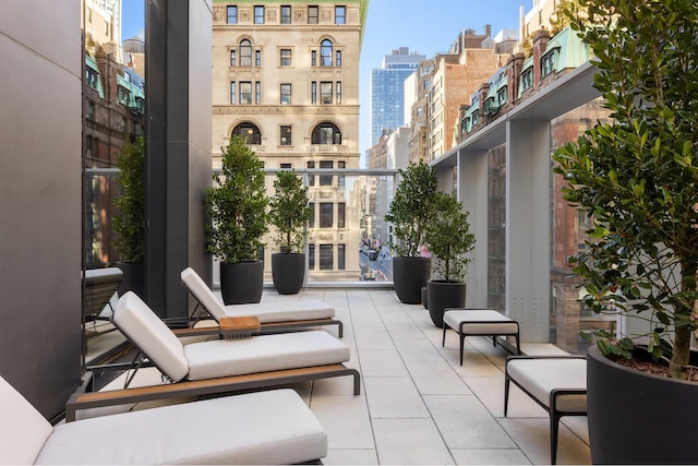 view of patio featuring a city view and a balcony