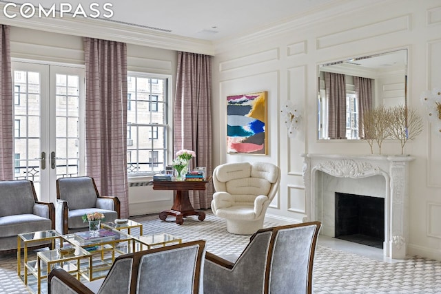 living area with a premium fireplace, ornamental molding, and french doors