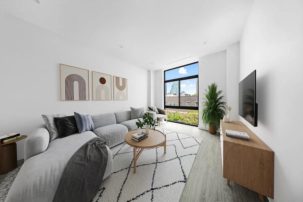 living room with expansive windows and wood finished floors