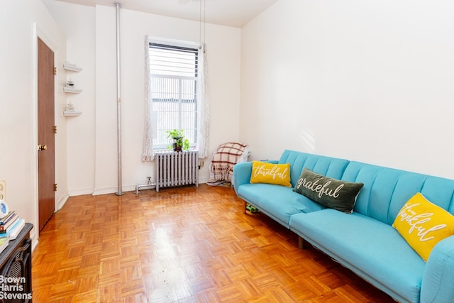 living room featuring light parquet flooring and radiator