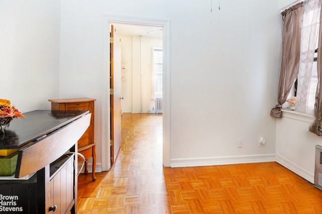 hall featuring radiator heating unit and light parquet floors