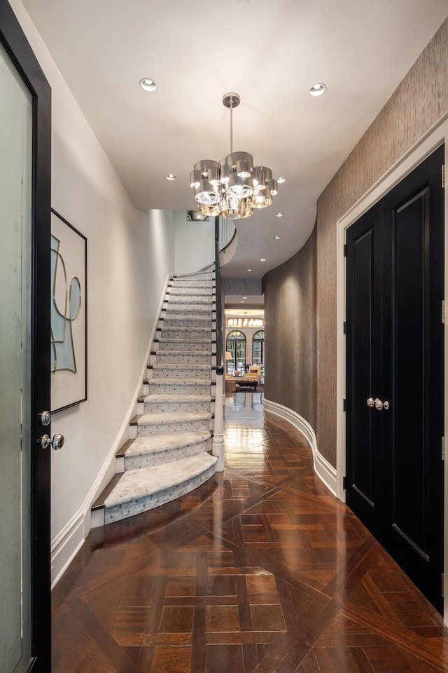 entrance foyer featuring stairs, recessed lighting, a notable chandelier, and baseboards