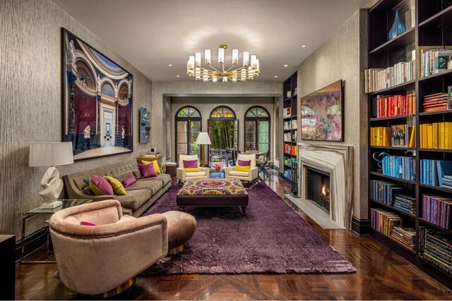 sunroom featuring a raised ceiling, plenty of natural light, and french doors