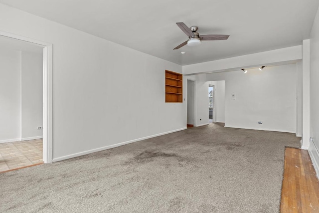 unfurnished room featuring ceiling fan and carpet floors