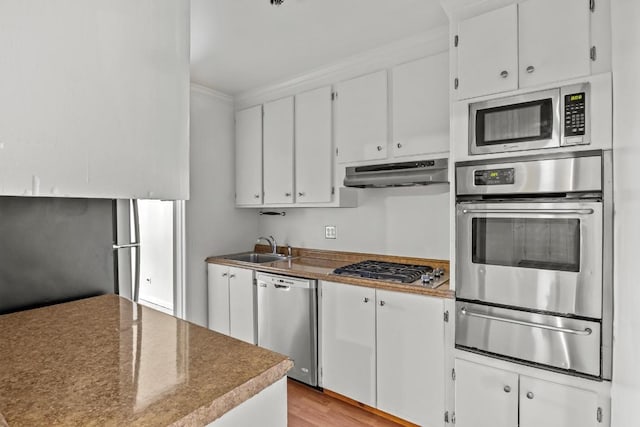 kitchen featuring light hardwood / wood-style floors, sink, white cabinetry, and stainless steel appliances