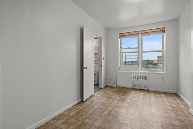 unfurnished room featuring radiator heating unit