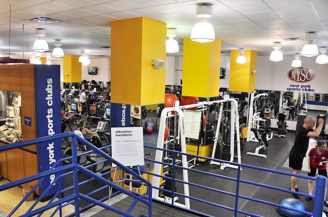 workout area with visible vents and a drop ceiling