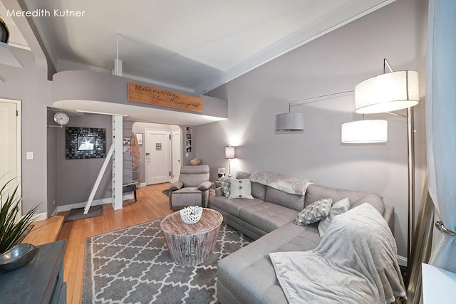 living area with ornamental molding, baseboards, and wood finished floors