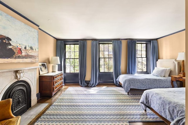 living area featuring crown molding, dark hardwood / wood-style floors, and a premium fireplace