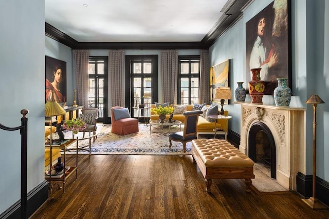 living area with hardwood / wood-style flooring and crown molding