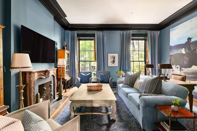 sitting room with crown molding and a wealth of natural light