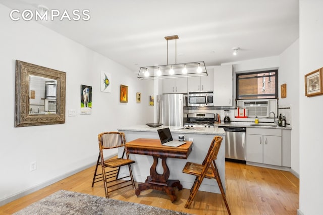 dining space with light wood finished floors and baseboards
