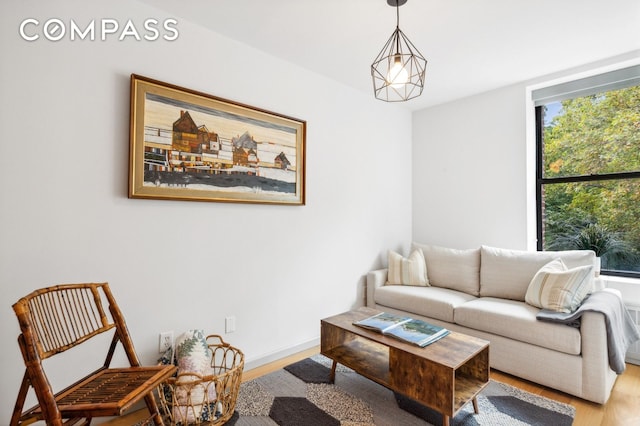 living area featuring wood finished floors and baseboards