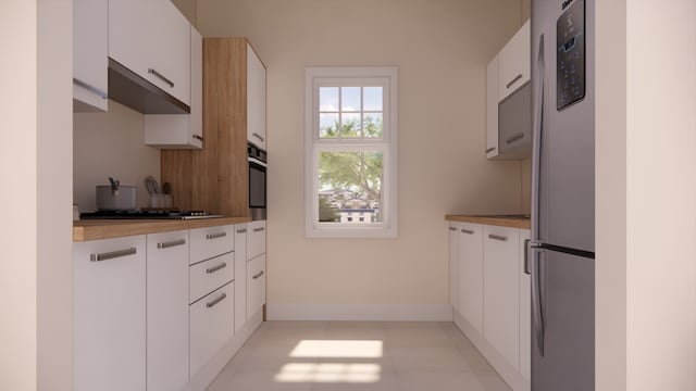 kitchen with light countertops, appliances with stainless steel finishes, and white cabinetry