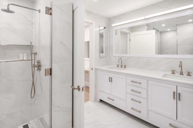 bathroom featuring vanity and a shower with door