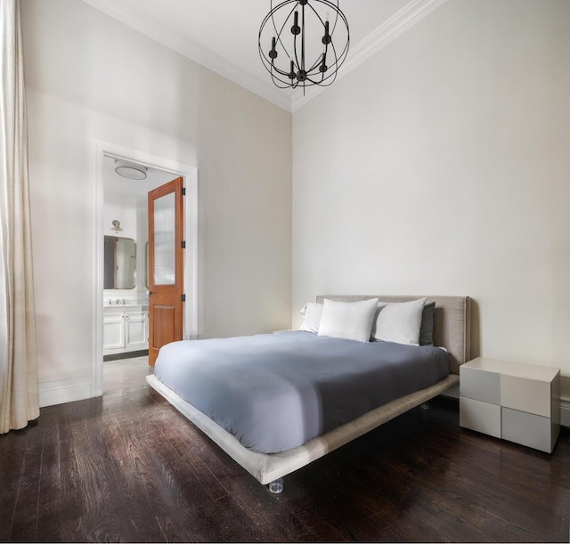 bedroom featuring ornamental molding, dark wood-type flooring, baseboards, and an inviting chandelier