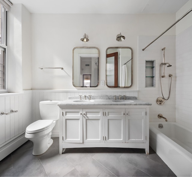 46 Mercer St Unit 4W, New York City, NY 10013 - full bathroom with toilet, shower / bath combo with shower curtain, double vanity, baseboard heating, and wainscoting