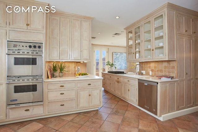 kitchen with sink, backsplash, and stainless steel appliances