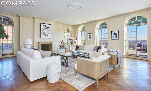 living room with parquet flooring, plenty of natural light, and ornamental molding