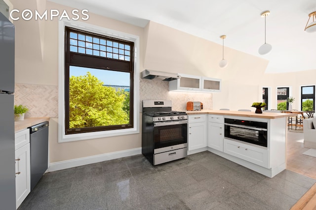 336 Convent Avenue Mltfmly, New York City, NY 10031 - kitchen with stainless steel appliances, custom range hood, a peninsula, granite floors, and white cabinets