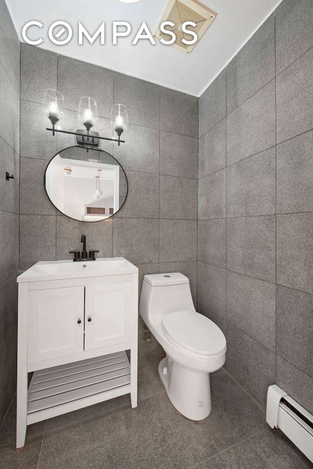 336 Convent Avenue Mltfmly, New York City, NY 10031 - bathroom featuring baseboard heating, tile walls, vanity, and tile patterned flooring