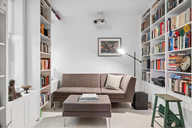 living area featuring wall of books