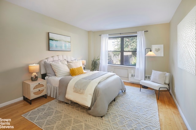 bedroom featuring light wood-style flooring and baseboards