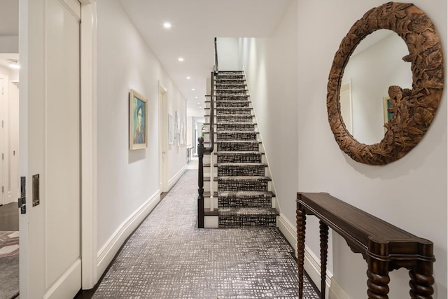 hall featuring baseboards and recessed lighting