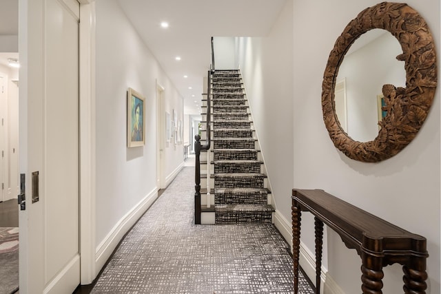 hallway with recessed lighting, stairway, baseboards, and carpet floors