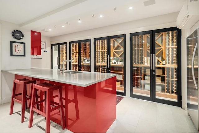 bar with recessed lighting, indoor bar, a sink, a wall mounted AC, and stainless steel fridge