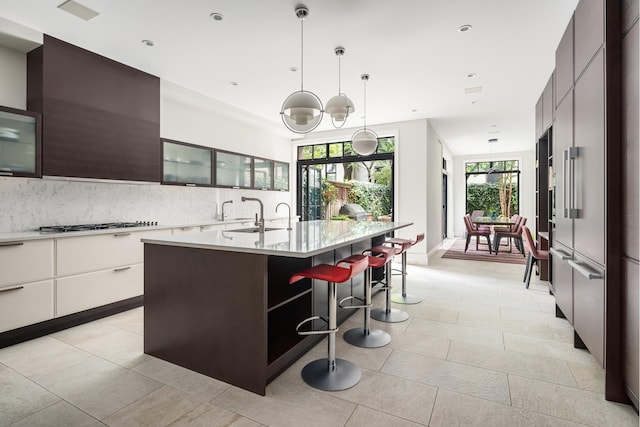 44 W 90th St, New York City, NY 10024 - kitchen with modern cabinets, light countertops, a breakfast bar, decorative backsplash, and recessed lighting