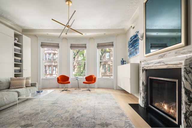 living room featuring a fireplace with flush hearth and light wood finished floors