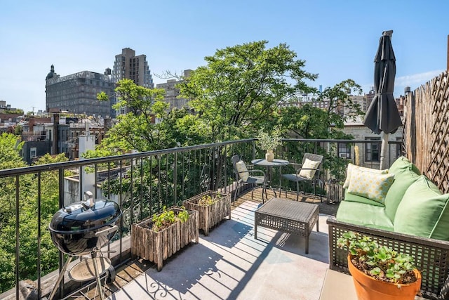 balcony featuring a view of city, an outdoor hangout area, and area for grilling