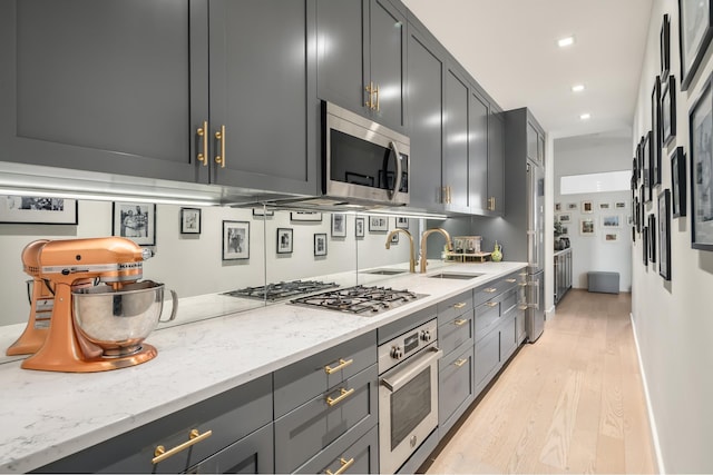 44 W 90th St, New York City, NY 10024 - kitchen with stainless steel appliances, light wood-style floors, light stone countertops, and recessed lighting