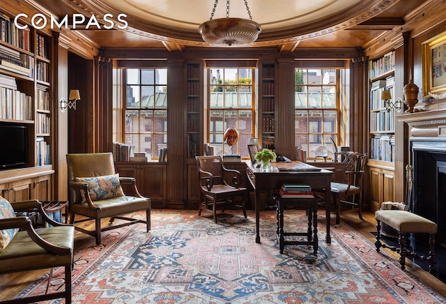 office space featuring built in features, wooden ceiling, ornamental molding, beam ceiling, and wood walls