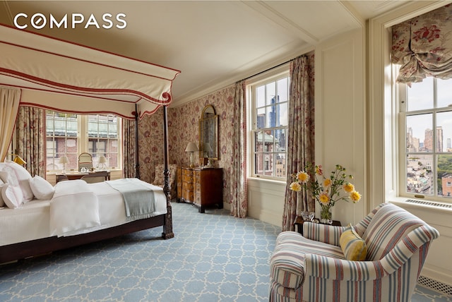 carpeted bedroom with a decorative wall and crown molding