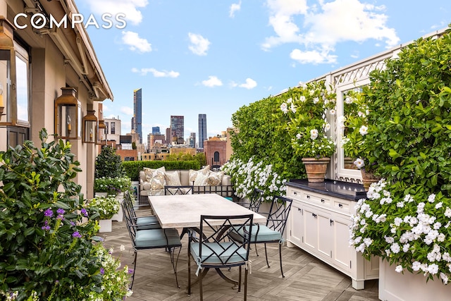 deck featuring a view of city and outdoor dining area