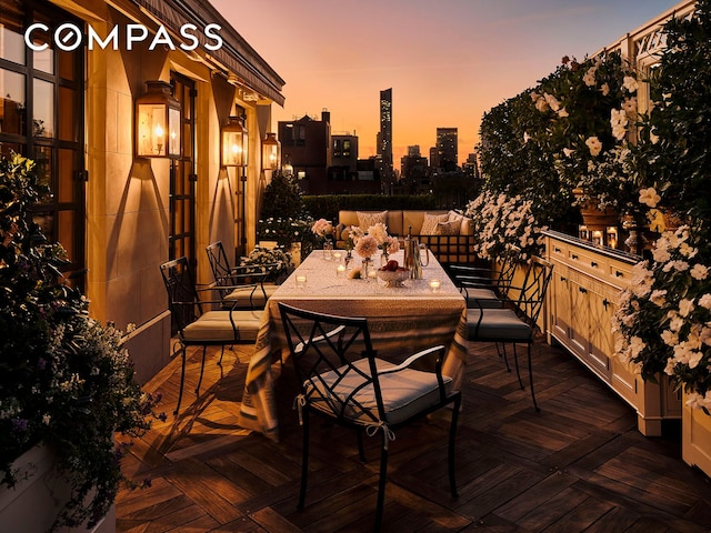 deck at dusk with a view of city