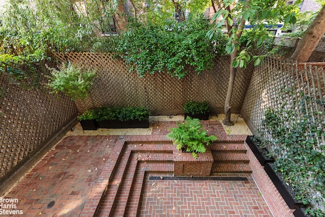 view of yard with fence and a patio