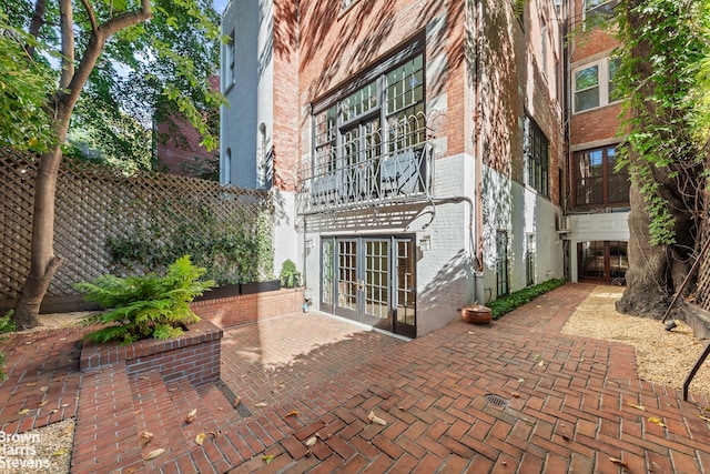 view of patio featuring fence and french doors