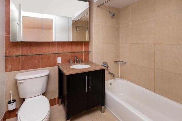 bathroom with tile patterned floors, toilet, tile walls, bathtub / shower combination, and vanity