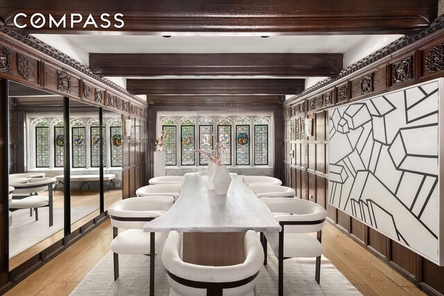 dining space featuring plenty of natural light, beamed ceiling, and light wood-style flooring