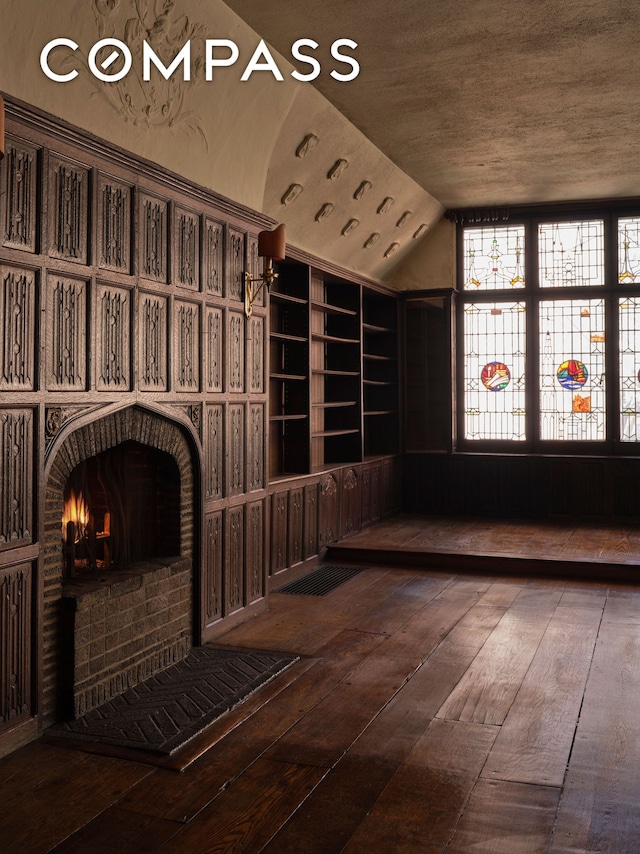 wine cellar with wood-type flooring and lofted ceiling