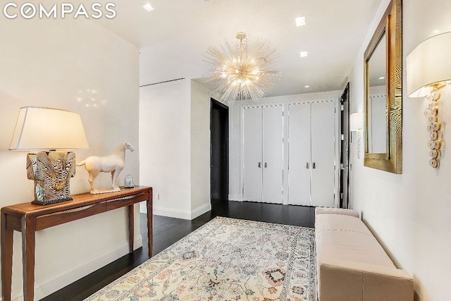 entryway with a chandelier and dark hardwood / wood-style floors