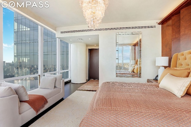 bedroom with wood-type flooring and an inviting chandelier