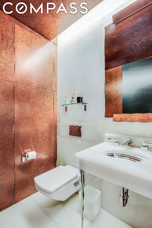 bathroom with toilet and tile patterned floors