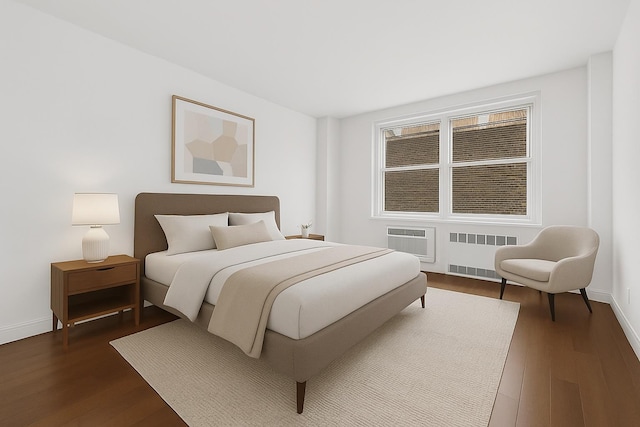 bedroom featuring baseboards, a wall mounted AC, dark wood-style floors, and radiator